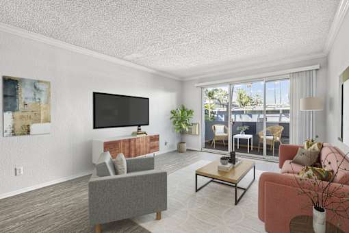 A living room with a grey couch, a red couch, a coffee table, and a television.