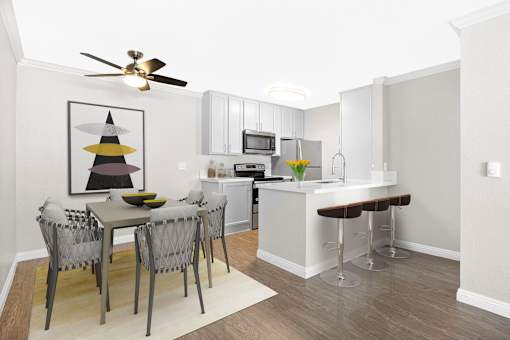 A kitchen with a table and chairs and a ceiling fan.