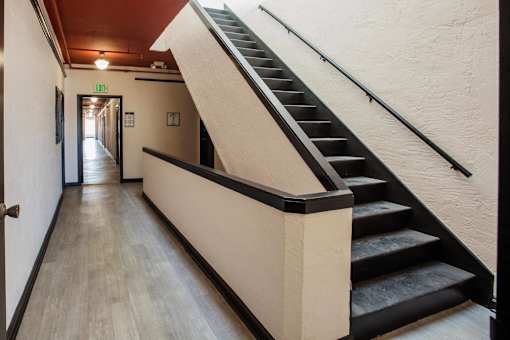 A hallway with a staircase on the right side.