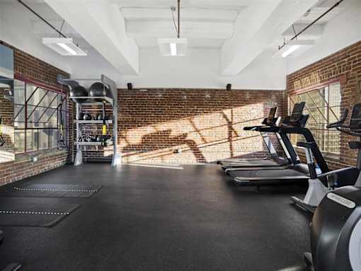 A gym with treadmills and weights.