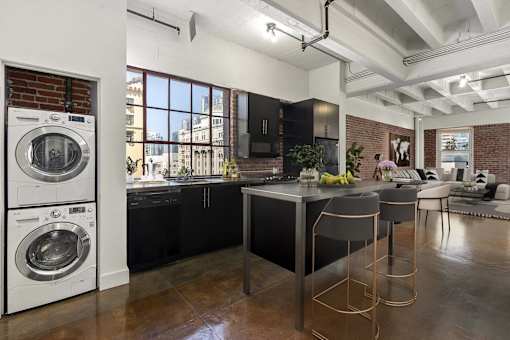 A modern kitchen with a large island and bar stools.