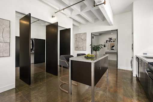 A black and white kitchen with a table and chairs.