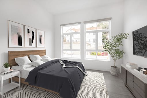 A bedroom with a large bed and a plant on the side table.