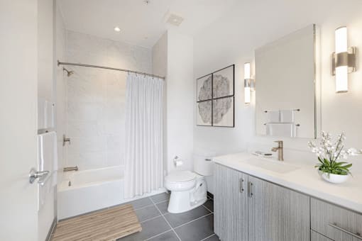 A white bathroom with a toilet, sink, and bathtub.