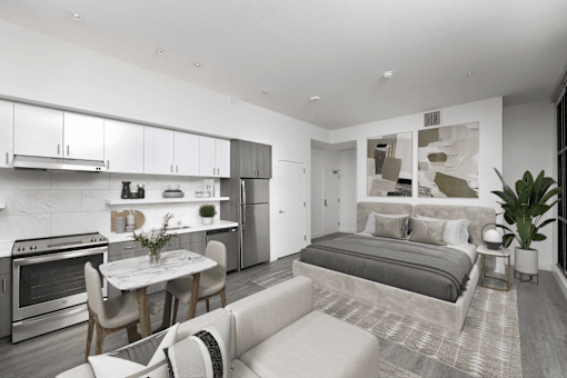 A modern kitchen with a dining table and a couch.