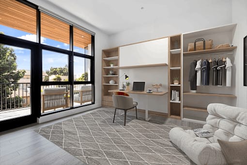 A modern living room with a sliding glass door and a grey sofa.