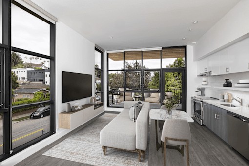 A modern living room with a large window and a flat screen TV.