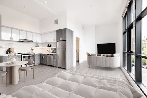 A modern kitchen with a dining table and chairs.
