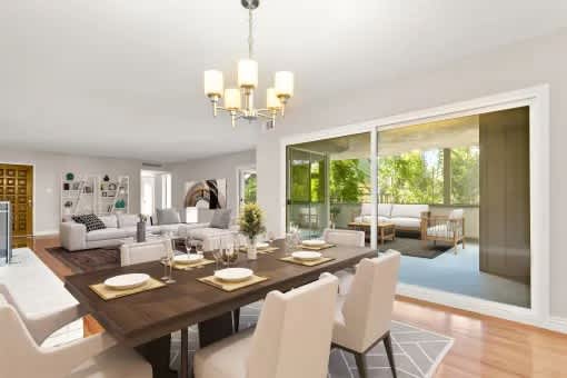 A dining room with a table set for six.