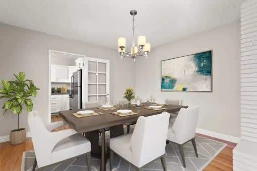 A dining room with a table set for four.