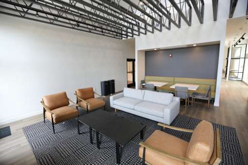 a large room with a couch and tables and chairs