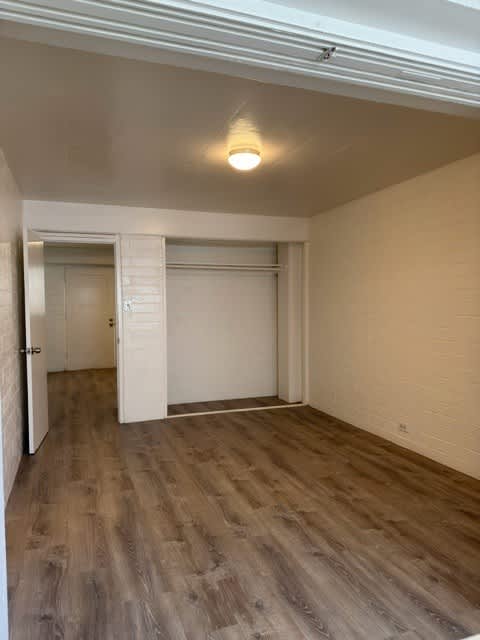 Pacific Oasis bedroom with a white door and a light on the ceiling.