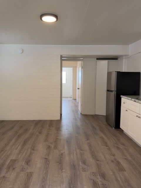 Pacific Oasis kitchen with a fridge and white cabinets.