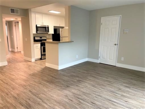 a kitchen Peachgrove Apartments Dining and Kitchenliving room with a wooden floor