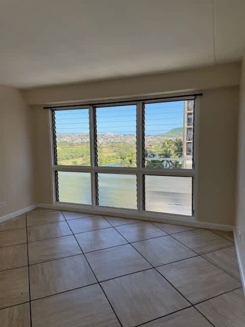 A room with a large window overlooking a landscape.