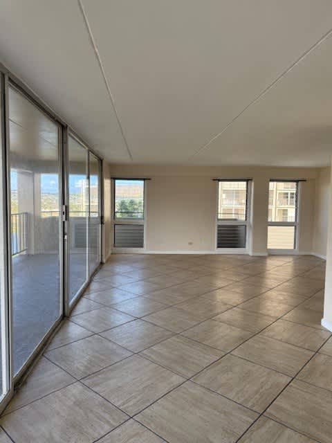 Napili Towers living room with tiled flooring and sliding glass doors.