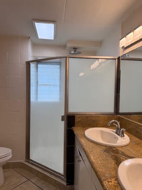 A bathroom with a sink, toilet and shower.