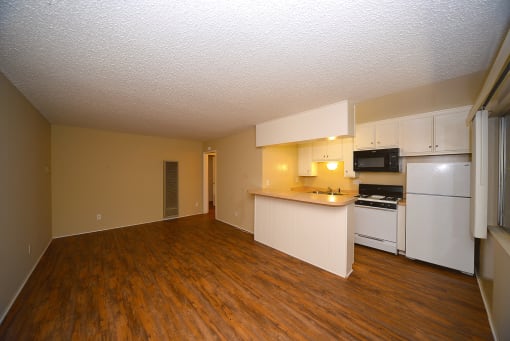 Ponderosa Apartments unfurnished living area with kitchen countertop