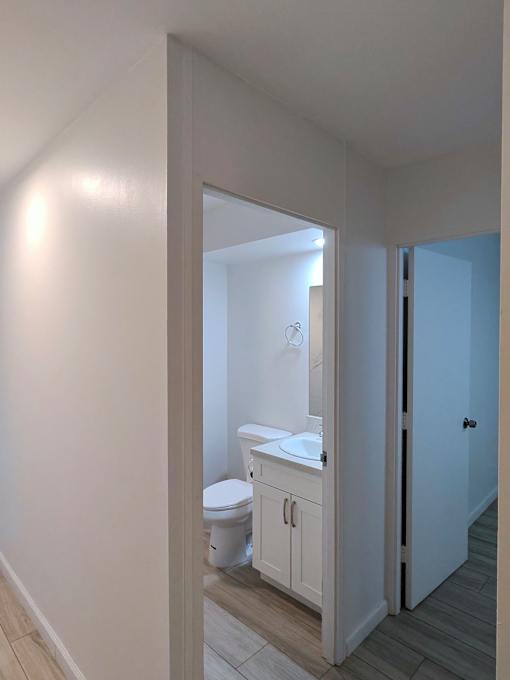 Punahou Circle bathroom with a toilet, sink, and cabinet.
