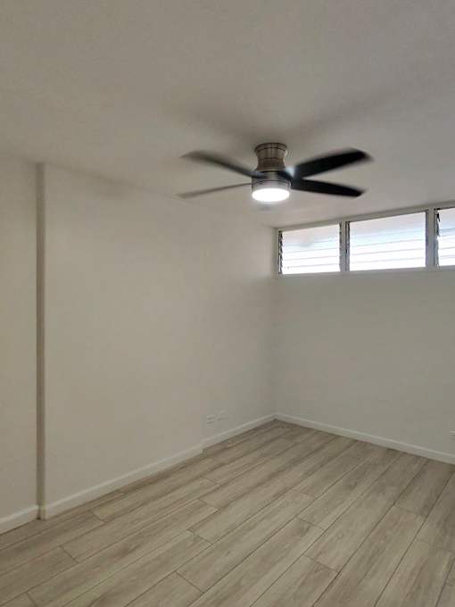 Punahou Circle bedroom with a ceiling fan and light fixture.