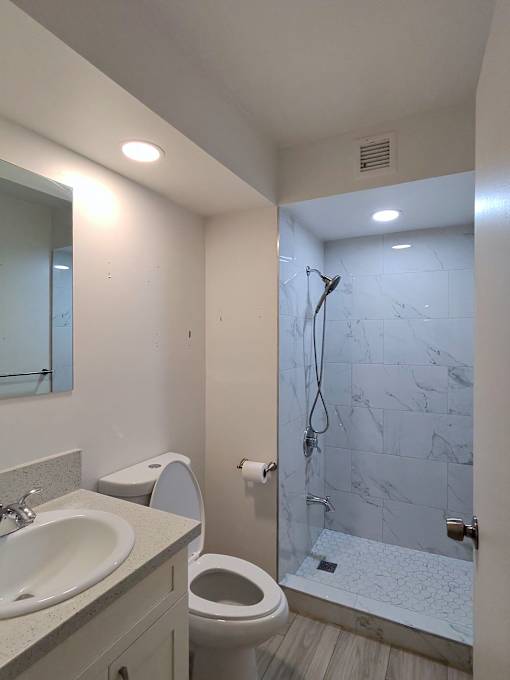 Punahou Circle bathroom with a toilet, sink, and shower.