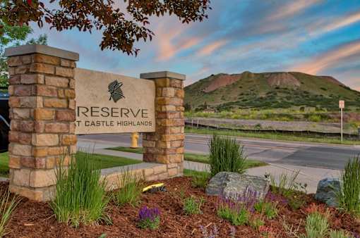 Reserve at Castle Highlands sign with a mountain in the background.