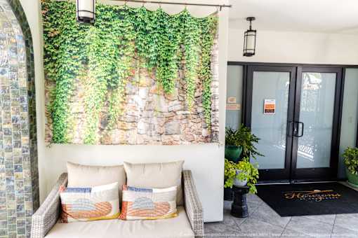Horizons at Calabasas entrance with greenery and a couch.