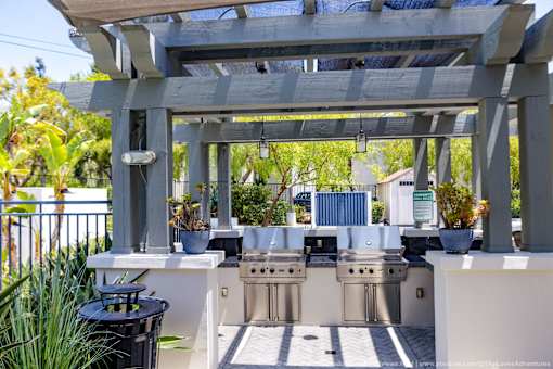 Horizons at Calabasas bbq area with grills and a table under a pergola.
