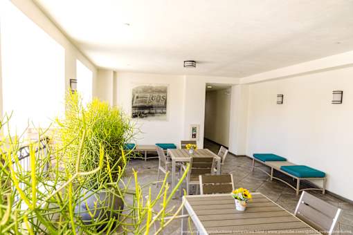 Horizons at Calabasas comunity patio with a table and chairs and a potted plant.
