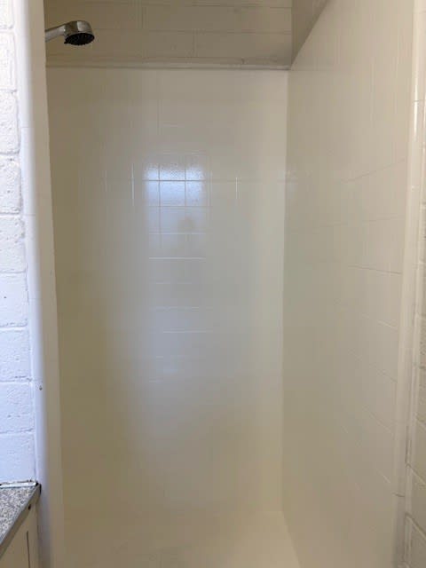 Pacific Oasis white tiled shower stall.