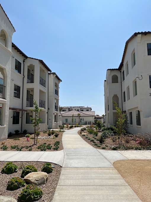 A white building with a blue sky in the background.