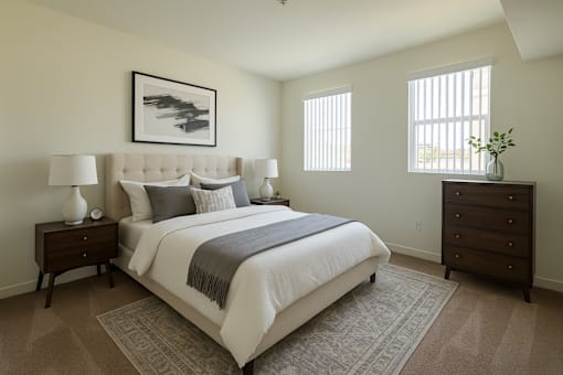 A bedroom with a large bed and a painting on the wall.