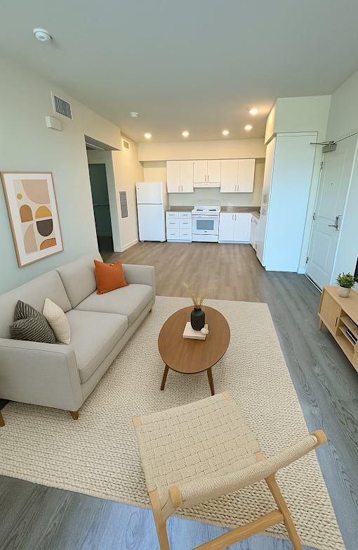 A living room with a grey couch and a coffee table.