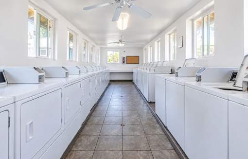 A laundromat with rows of washers and dryers.