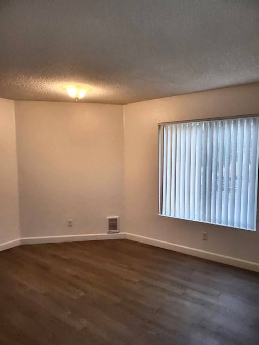 A room with a window and a light on.