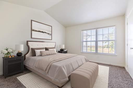 A bedroom with a large bed and a window.