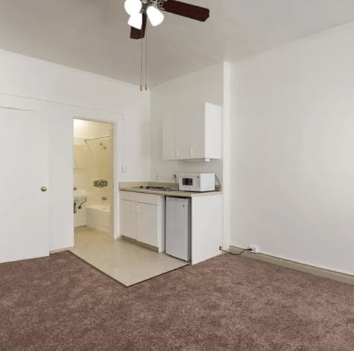 an empty kitchen with a microwave and a sink