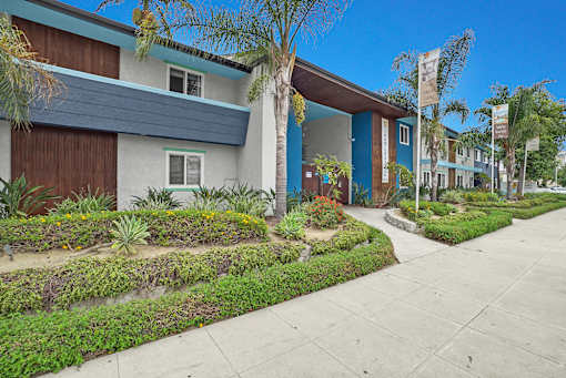 A row of houses with a blue sky in the background.