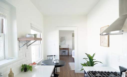 A kitchen with a black stove top oven and a black table.
