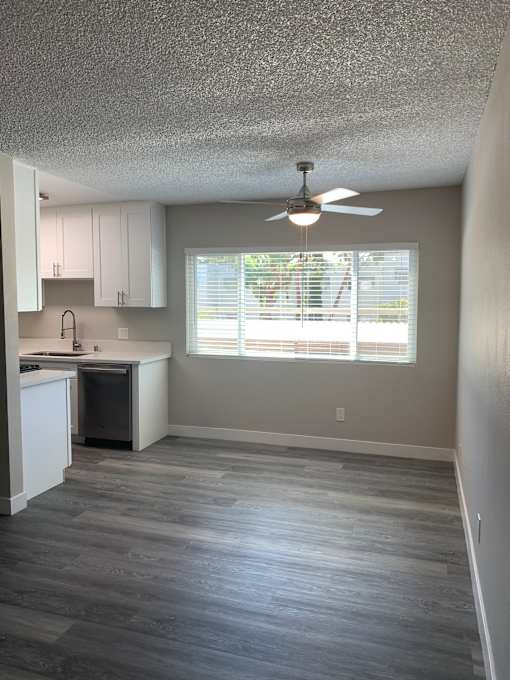 A bathroom with a fan and a window.