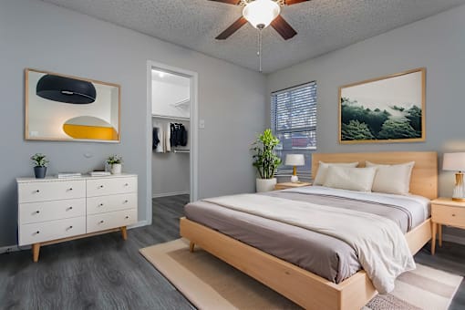 a bedroom with a bed and a ceiling fan