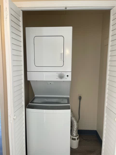 Napili Towers stacked washer and dryer in a closet.