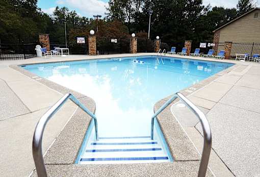 A pool with a metal ladder leading into the water.