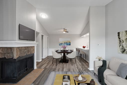 a living room with a fireplace and a table with chairs