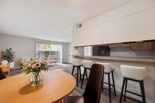 A dining room with a wooden table and chairs.
