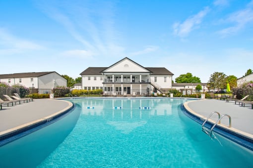 a large swimming pool with a building in the background