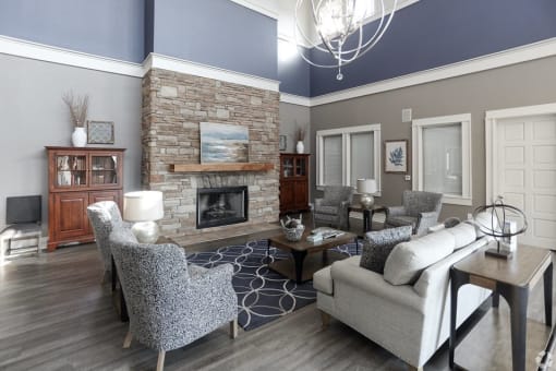 a living room with couches and chairs and a fireplace