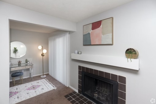 a living room with a fireplace and a desk