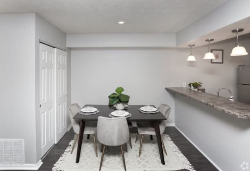 a dining room with a table and chairs
