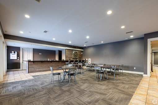A large room with a long table and chairs.